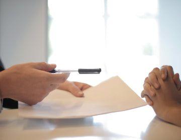 Closeup of two people discussing a document