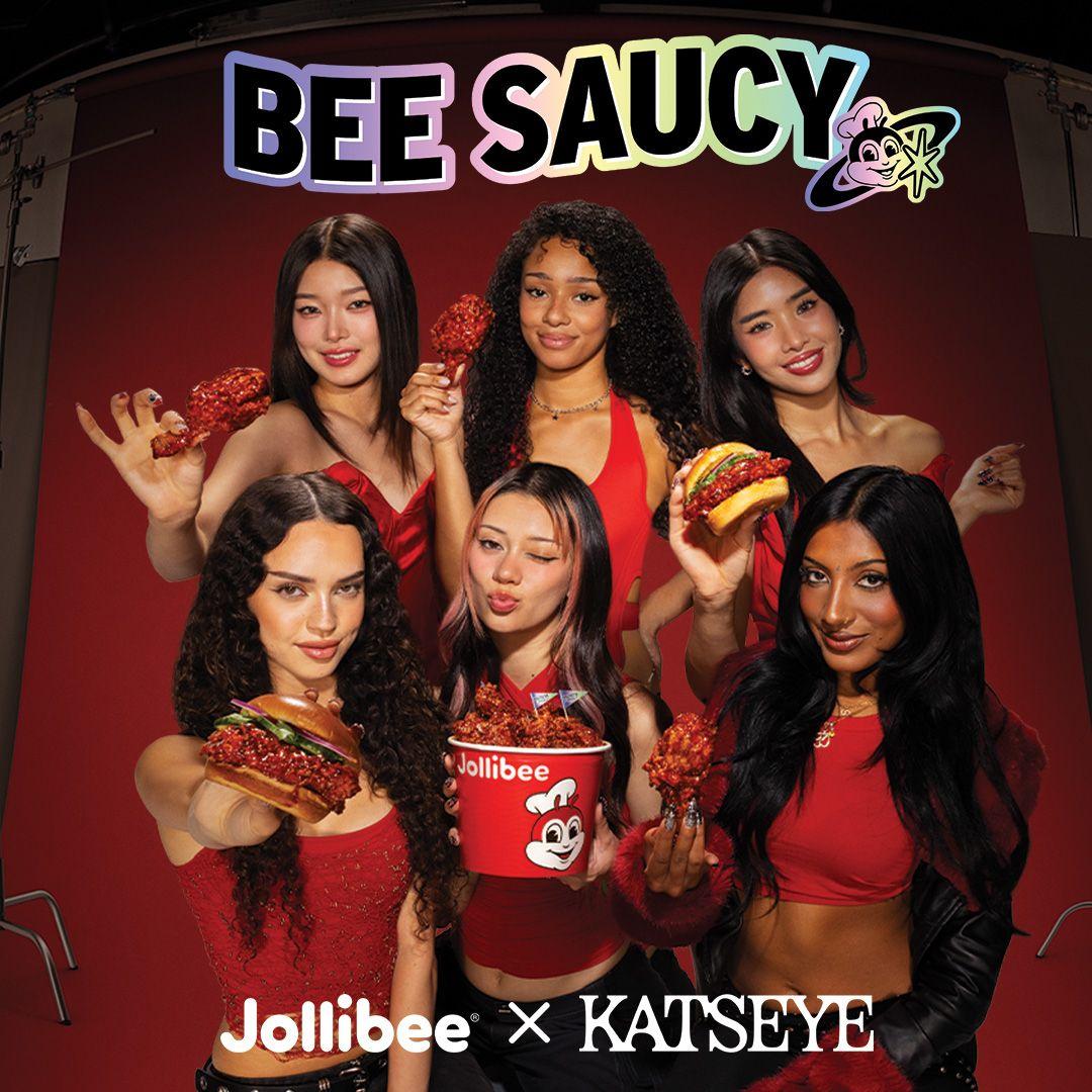 Group photo of KATSEYE holding Jollibee KBBQ fried chicken items with 'BEE SAUCY' and 'Jollibee x KATSEYE' text.