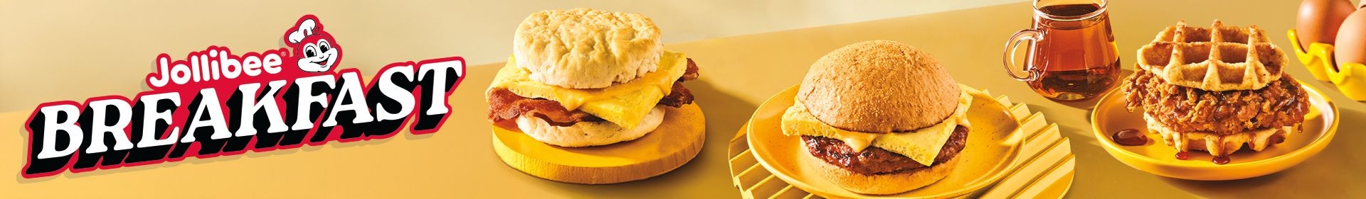 A sausage, egg, and cheese biscuit, longanisa breakfast sandwich, and chicken and waffles sandwich with the Jollibee logo and 'BREAKFAST' text on yellow background