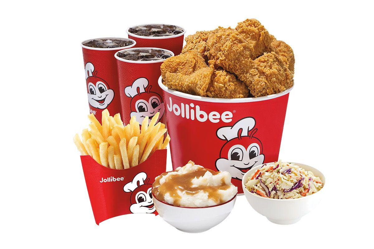 a bucket of fried chicken with three fountain drinks, french fries, mashed potato, and coleslaw on a white background.